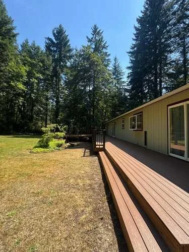 Timber deck beside a home in a wooded setting